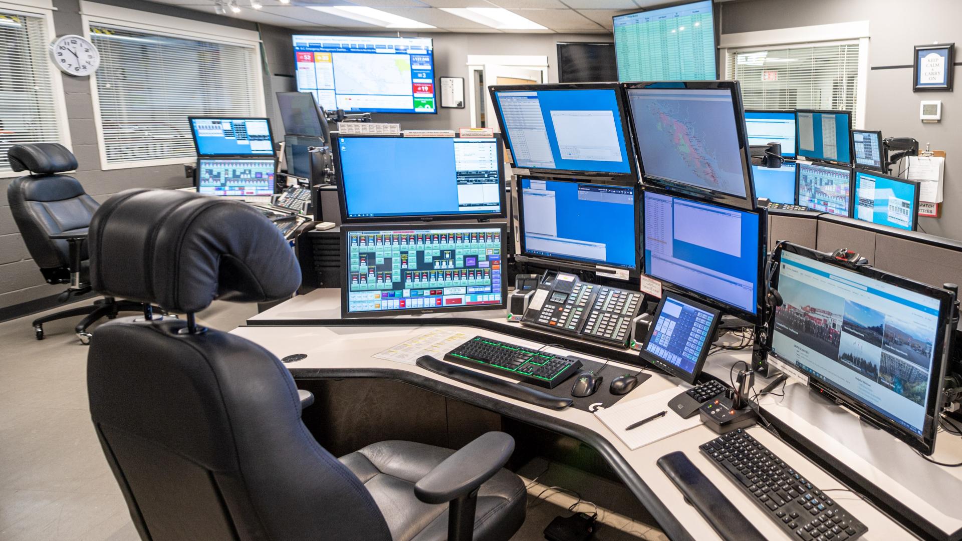 Workstations with multiple computer monitors, keyboards, and phones