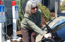 Local electric vehicle owner Kathy Denton charges her Nissan Leaf at the Visitor Information Centre during the City Grand Opening of the charging stations on Earth Day  - April 22, 2013