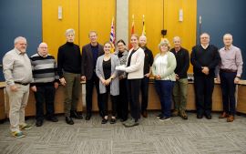 Members of the City’s Joint Occupational Health and Safety Committee accept the BC Municipal Safety Association Organizational Safety Excellence Award alongside Council. They are gathered in Council Chambers at City Hall.