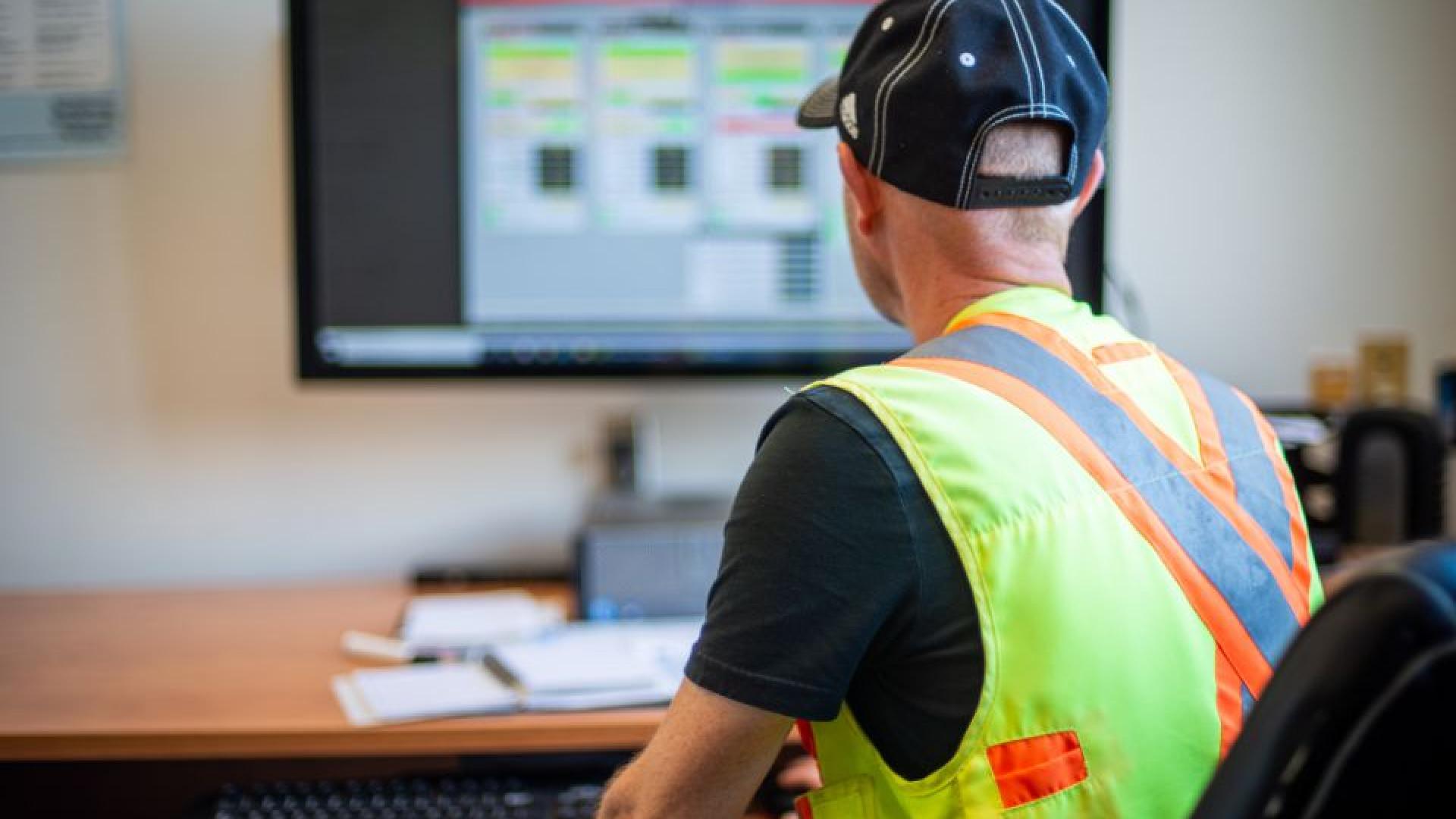 person facing a computer screen doing some work.