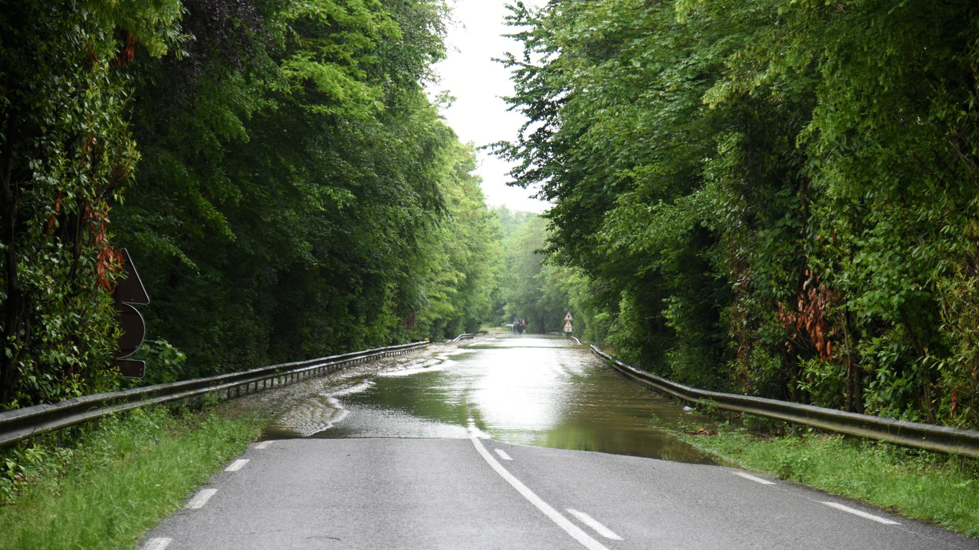 Storm water covers a road.