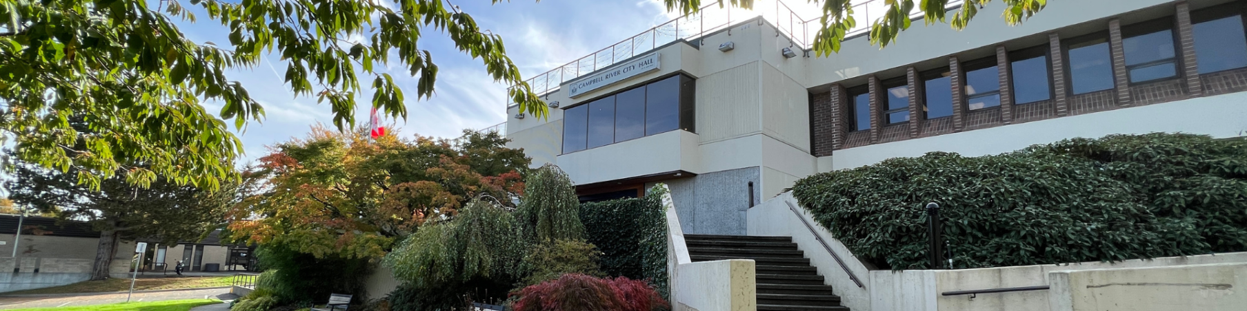 The front of City Hall with stairs leading up to the front entrance.