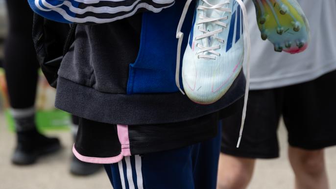 Soccer player holding cleats